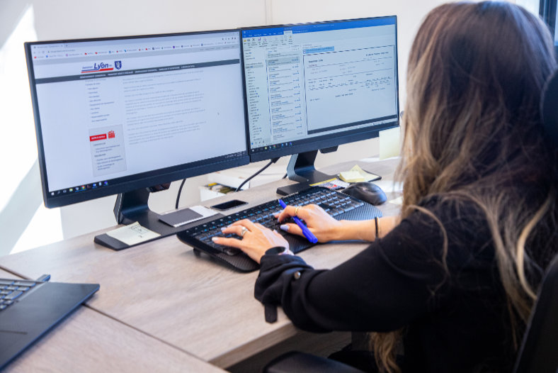 A woman typing at a computer